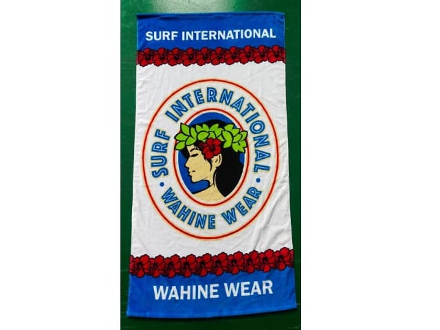 A towel with the words surf international wahines wear on it.