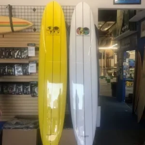 Two surfboards are sitting side by side in a store.