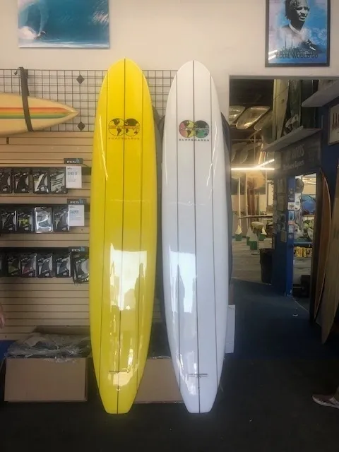 Two surfboards are sitting side by side in a store.